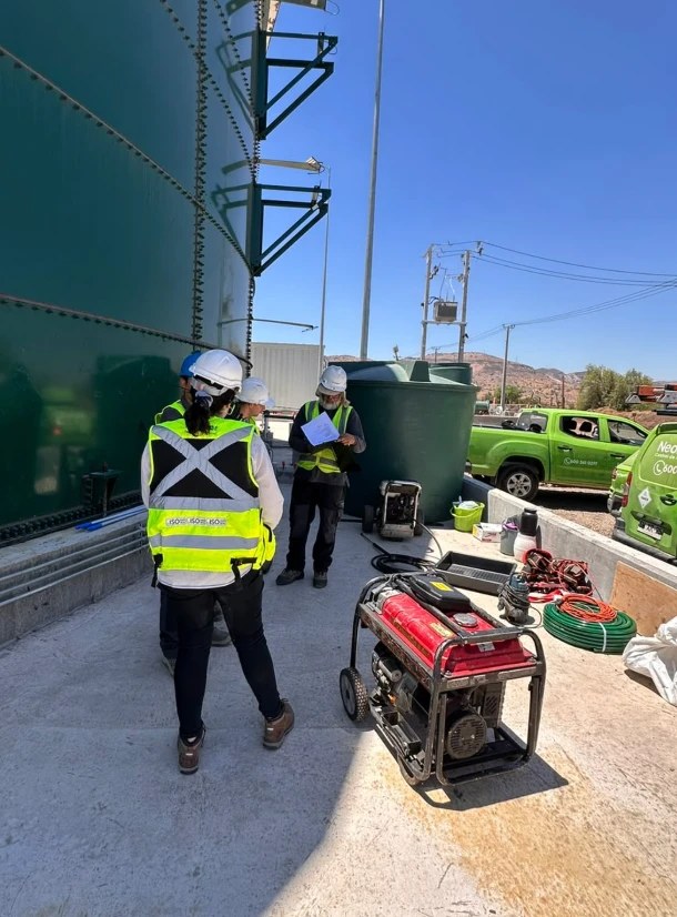 Técnicos de Neoplagas revisando el procedimiento antes de limpiar un estanque de agua potable